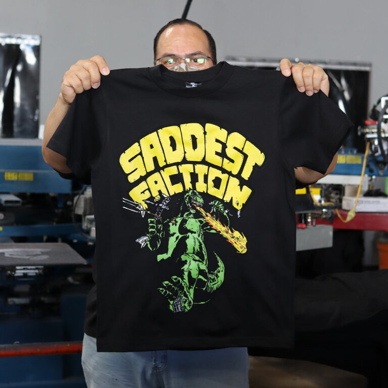 Front view of Custom Puff Screen Printed TeeStyled TS7000 T-shirt for The Saddest Faction Clothing Company.