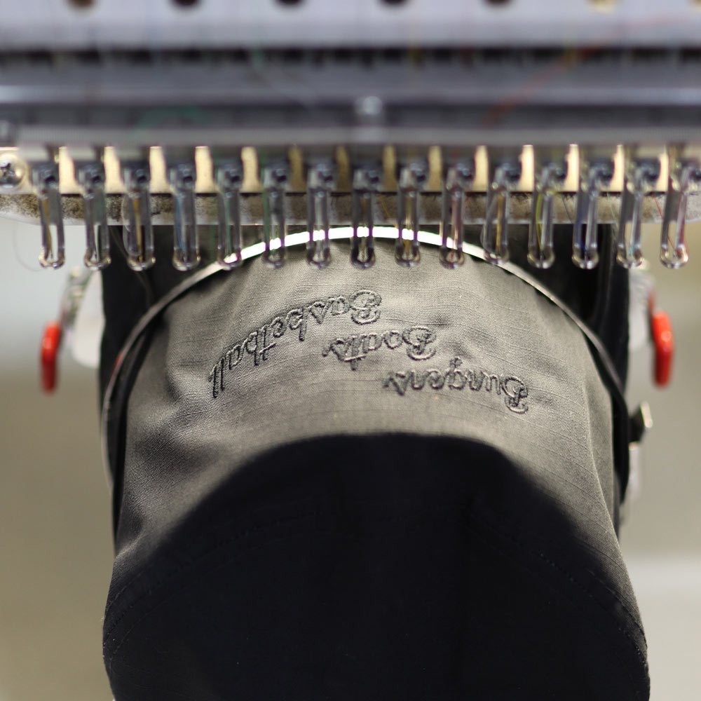 This photo is of a custom embroidery bucket hat​ in black zoomed in