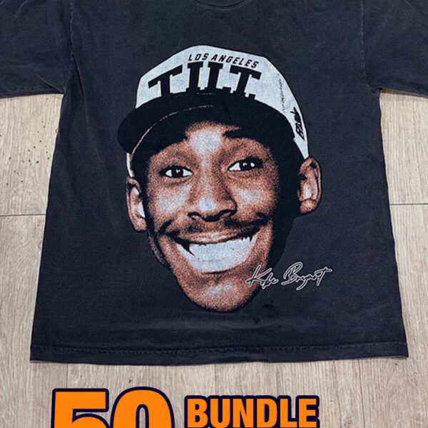 A black "36 Custom Streetwear T-Shirts – Heavyweight Garment-Dyed Cotton" graphic T-shirt with a smiling face design is displayed on a wooden floor. Text reads "50 BUNDLE $22.95 PER.