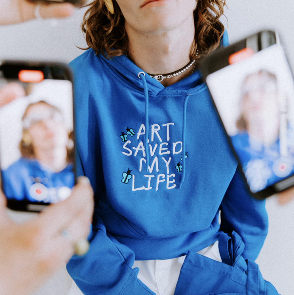 Custom Embroidered LS14001 Premium Pullover Hoodies with a design that reads "Art Saved My Life" on the front.