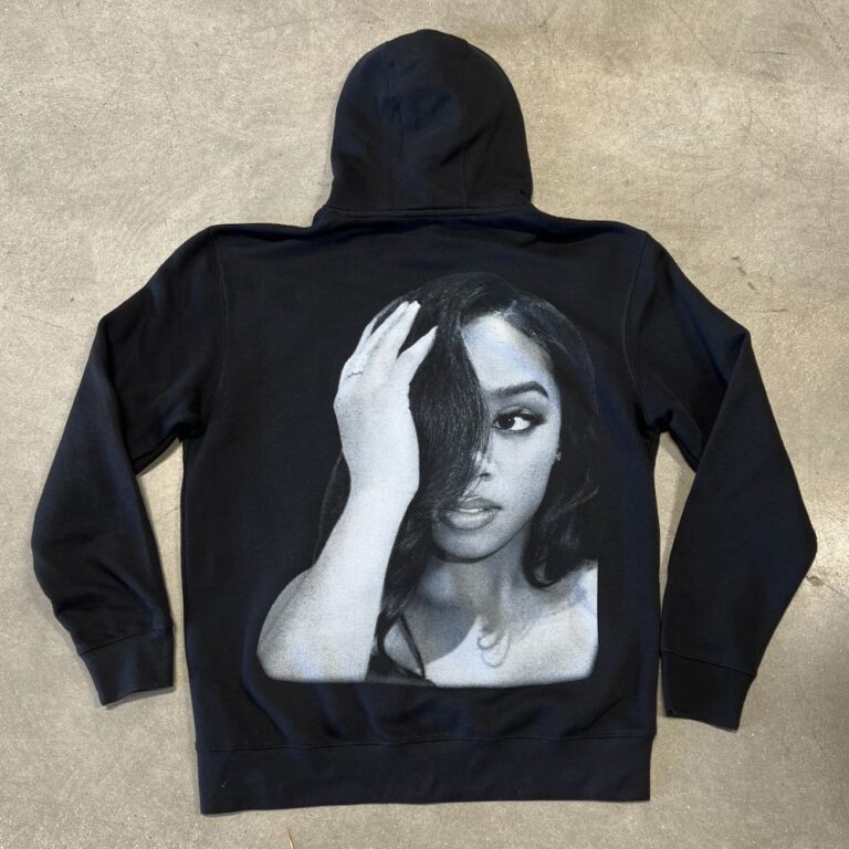 This is a flat photo of LA Apparel's HF09GD black hoodie with a jumbo screen printed design for the artist H.E.R.