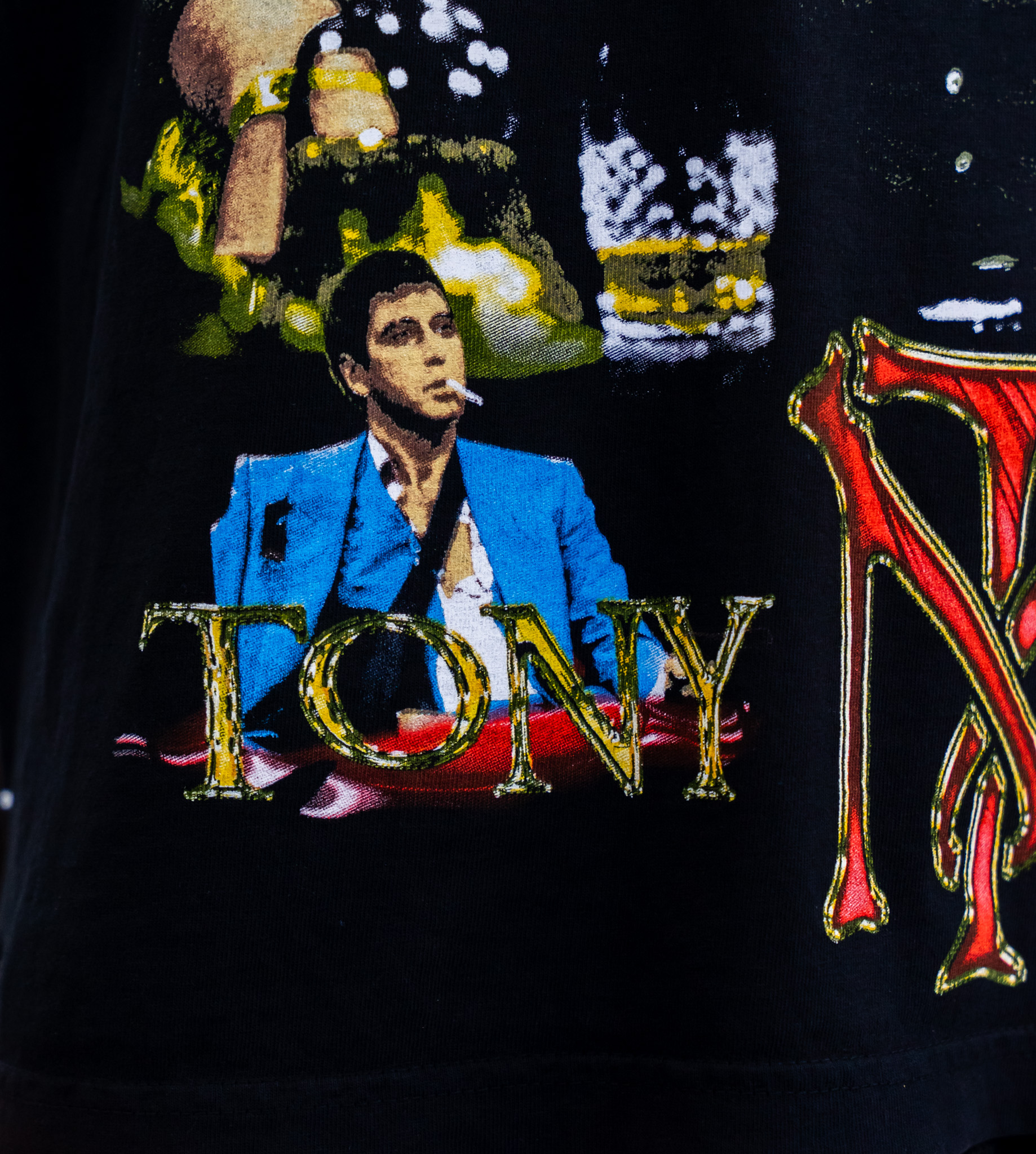 Black T-shirt with jumbo screen print of Tony Montana from the movie Scarface