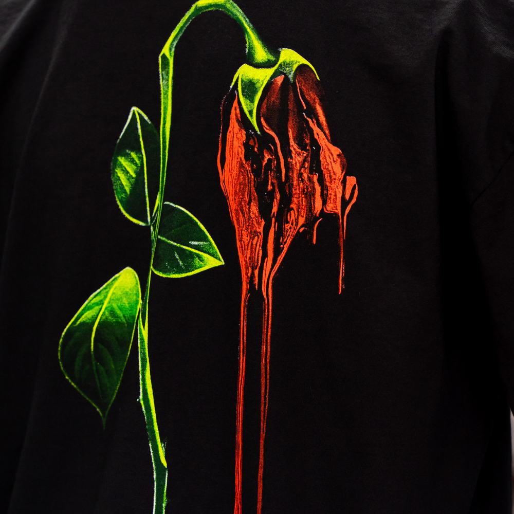 Zoomed in photo of a jumbo screen print on a Los Angeles Apparel 1801GD black t-shirt.