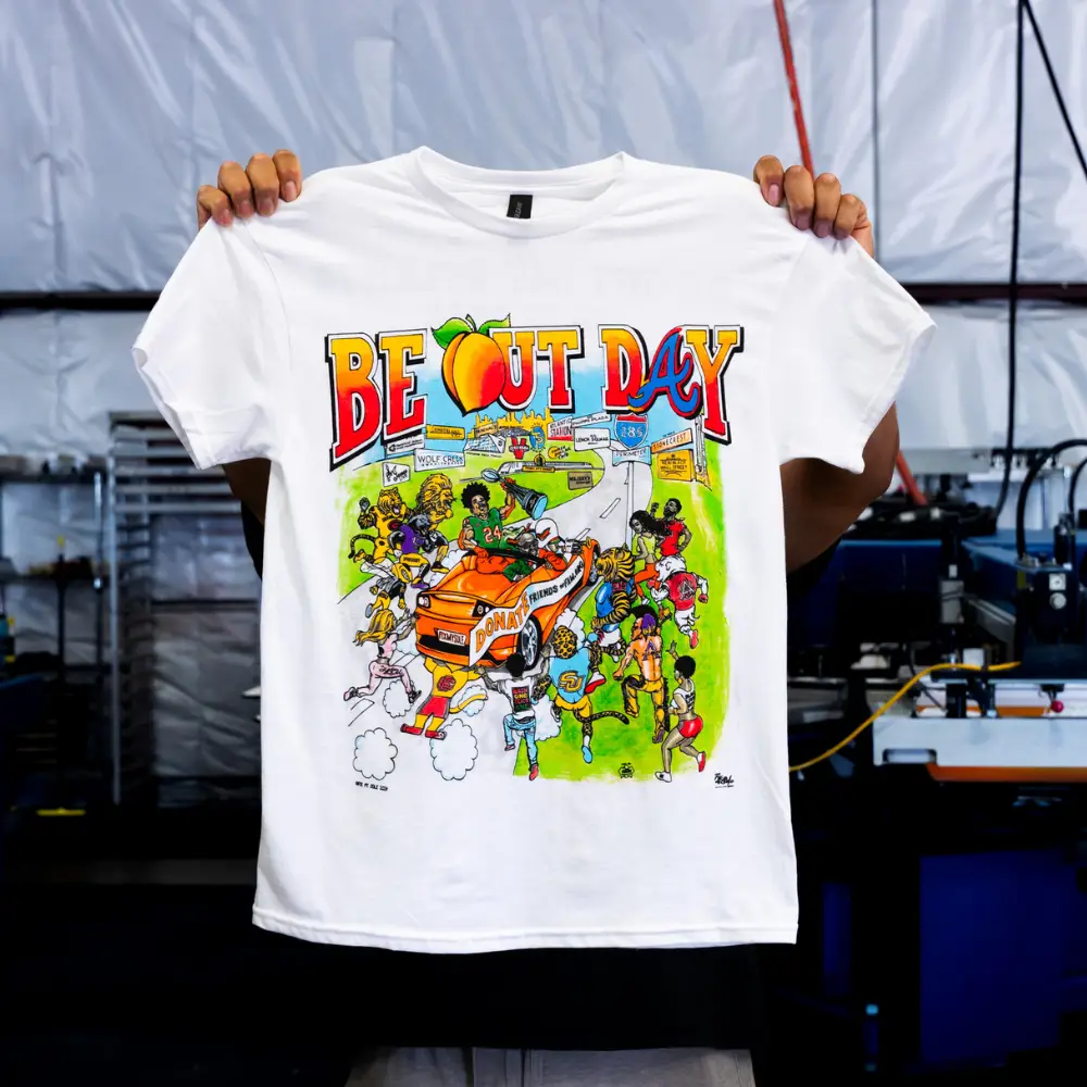 This is a photo of a man holding a white Gildan 64000CVC Softstyle® CVC T-Shirt with 8 color simulated process custom screen printing design on the front view