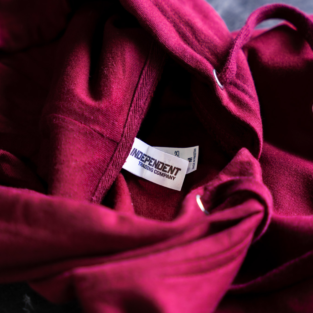 This is a photo of a maroon hoodie with an Independent Trading Tearaway tag style SS4500.