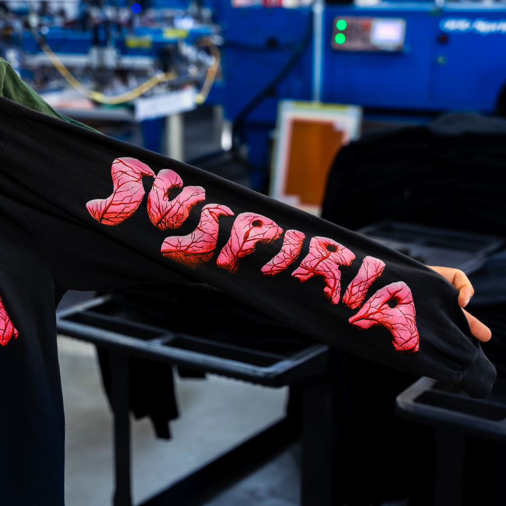 Sleeve view of a black Los Angeles Apparel 1807GD long sleeve with a Suspiria movie design, featuring vibrant screen printing by Garment Decor.