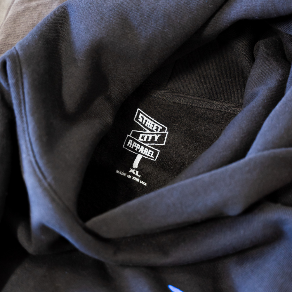 Black Independent Trading Style IND420XD hoodie with custom gray screen printed neck tags for Street City Apparel.