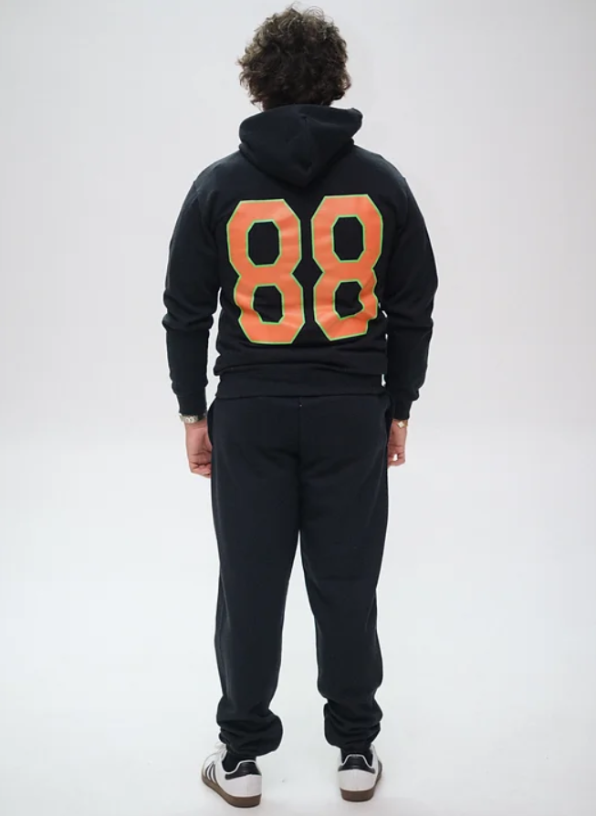 Lane Seven LS14001 Premium Pullover Hoodie and LS16006 Urban Sweatpants in black with custom Yang design, front view by Garment Decor